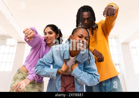 Junge Gruppe multiethnischer Hip-Hop-Tänzer in farbenfrohen urbanen Streetwear-Tänzen - stilvolles multirassisches Rap-Crew-Porträt im Tanzstudio Stockfoto