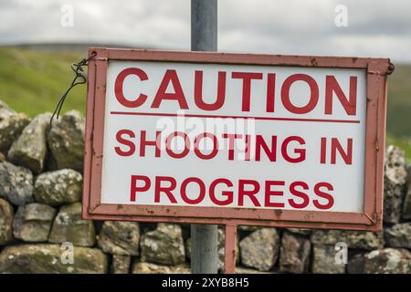 Schild: Vorsicht, Schießerei läuft, auf dem Weg zwischen Dufton und High Cup Nick, Cumbria, England, Großbritannien Stockfoto