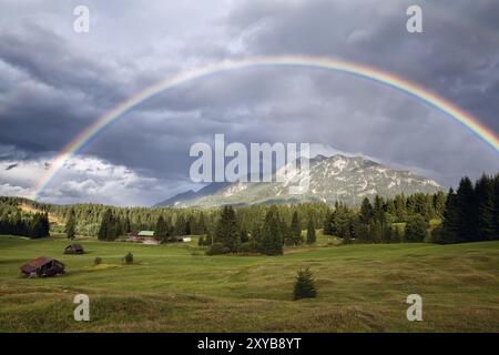 Farbenfroher Regenbogen über Karwendelalpen und Wiesen, Bayern, Deutschland, Europa Stockfoto