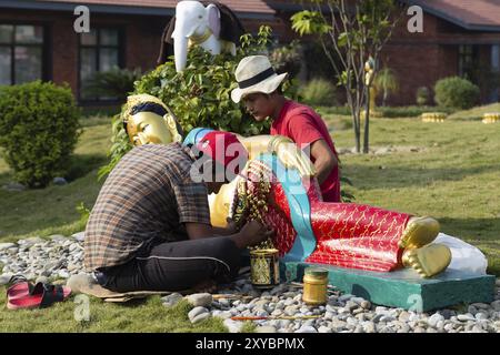 Lumbini, Nepal, 26. November 2014: Foto von Arbeitern, die Buddha-Statuen in der Tara-Stiftung Lotus Stupa, auch bekannt als Deutscher Tempel, A Stockfoto