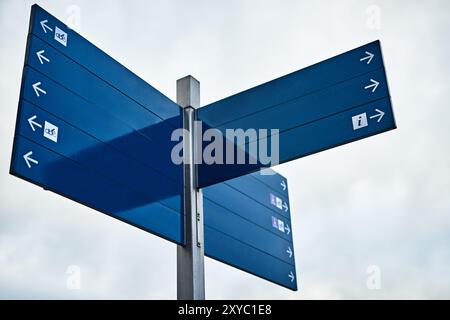 Fahren, Pfeil und Straßenschild im Freien für Richtung, Lage und Bauanleitung in der Stadt mit Modell. Straße, Symbol und Infrastruktur für Drive, Way Stockfoto