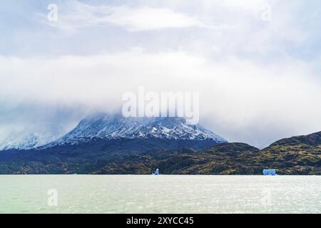 Blick auf den wunderschönen Schnee berg mit Nebel mit Eisberg brechen sie Grey Gletscher bedeckt und schwimmend auf dem Grauen See im südlichen chilenischen Patagonien, Chil Stockfoto