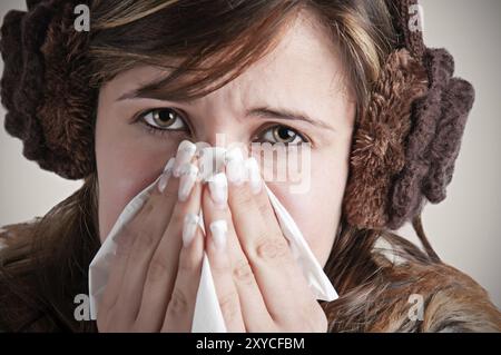 Blasse kranke Frau mit einer Grippe Niesen, in einem dunklen Hintergrund Stockfoto