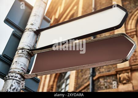 Gebäude, Pfeil und Straßenschild im Freien für Wegbeschreibung, Lage und Reiseführer in der Stadt mit Mockup. Straße, Symbol und Infrastruktur für Drive, Way Stockfoto