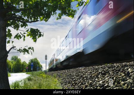 Vorbeifahrender Personenzug aus Froschperspektive Stockfoto