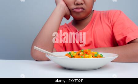 Kinder essen nicht gerne Gemüse, kleiner niedlicher Junge weigert sich, gesundes Gemüse zu essen, Ernährung gesunde Essgewohnheiten für Kinder Konzept, Kinder Stockfoto