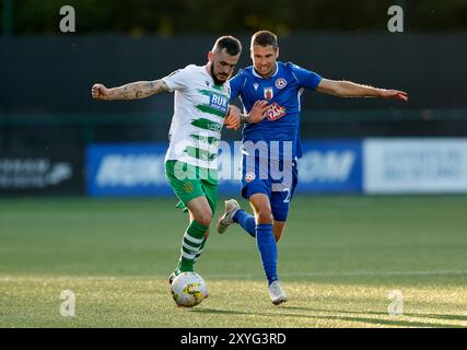 Die New Saints' Leo Smith und Panevezys' Jovan Cadenovic (rechts) kämpfen um den Ball während der Play-off-Runde der UEFA Conference League, dem zweiten Legspiel im Park Hall Stadium, Oswestry. Bilddatum: Donnerstag, 29. August 2024. Stockfoto