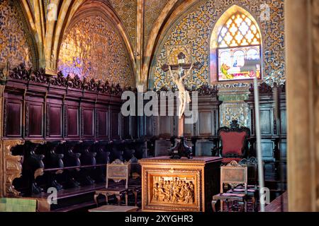 SINTRA, Portugal – die Kapelle des Pena-Palastes, ursprünglich Teil des frühen Klosters der Hieronymiten-Mönche, zeigt einen Alabaster-Retabel aus dem 16. Jahrhundert von Nicolau Chanterene. Das gotische Kirchenschiff ist mit Spitzbögen und monochromen Fliesen aus dem 16. Jahrhundert geschmückt, während Apsis und Chor mit gewölbten, mit polychromen Fliesen aus dem 17. Jahrhundert gesäumten Bögen bedeckt sind. Die Kapelle wurde später von König Ferdinand II. Als seine pfälzerkapelle genutzt. Stockfoto