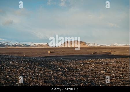 Solheimasandur Wüste in Island, mit schneebedeckten Bergen bei Sonnenuntergang Stockfoto