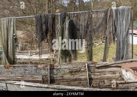 Fischernetze mit einem alten Holzboot im Vordergrund Stockfoto