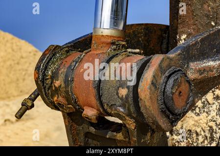 Detail der rostigen und schmutziges Öl Zahnrad von einem Bulldozer am Strand Stockfoto