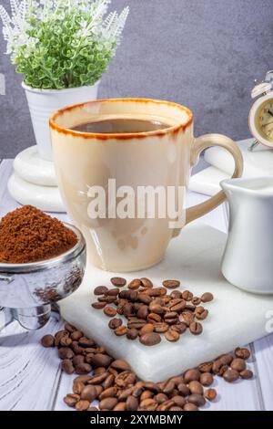 Kaffeetasse mit Bohnen und Sahne Stockfoto