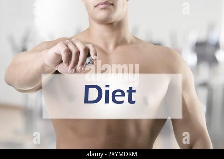 Fit Mann zu etwas auf einer leeren Karte schreiben Stockfoto