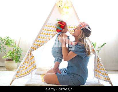 Mutter und nettes Mädchen spielen zusammen in Innenräumen Stockfoto