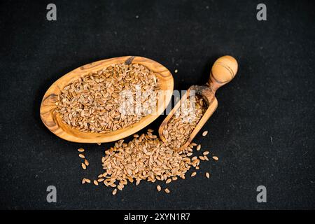 Gemeiner Flachs (Linum usitatissimum), Leinsamen auf Holzplatte und Schaufel Stockfoto