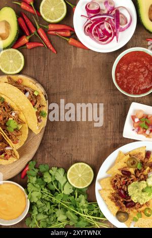 Ein Foto von einem ssortment vieler verschiedener mexikanische Lebensmittel, wie Tacos, Guacamole, Pico de Gallo, Nachos und andere, mit Kopie Raum Stockfoto