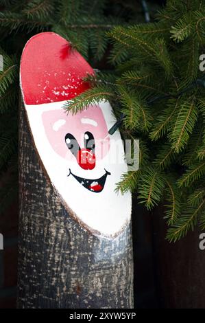 Pater Christmas's Gesicht auf der Schnittfläche eines Baumstamms Stockfoto