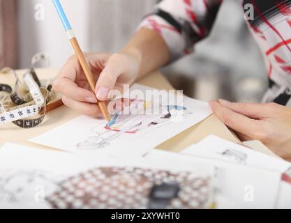 Schneiderin ist eine Mode-Skizze zeichnen. Nahaufnahme der Hände Stockfoto