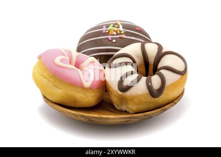 Leckere Donuts in Holzplatte auf weißem Hintergrund Stockfoto