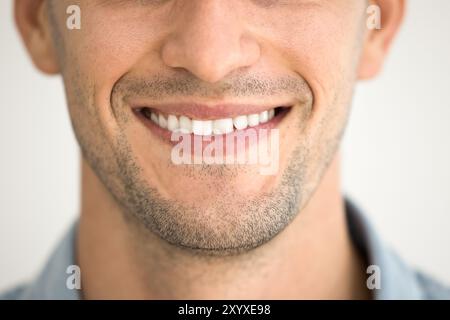 Nahaufnahme von männlichem Zahnlächeln, rasiertes Kinn mit Stoppeln Stockfoto
