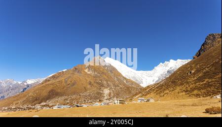 Panorama der schneebedeckten Langtang Lirung Himalaya-Gebirge mit Kyanjin Gompa Dorf im Vordergrund in Nepal. Vor 2015 Gorkha Earthquak Stockfoto