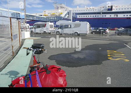 Mehrere Wohnmobile parken auf einem Fährparkplatz, mit einer großen Fähre im Hintergrund, Transport, Fähre nach Norwegen, Hirtshals, Jütland, Dänemark, Euro Stockfoto