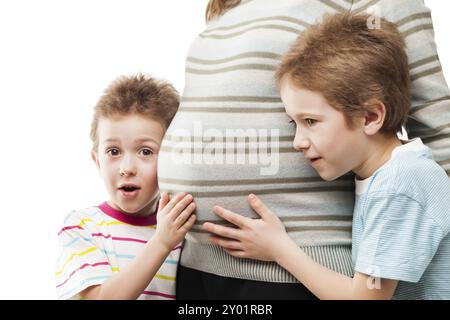 Schwangerschaft und neues Lebenskonzept, zwei kleine Junge Brüder, die schwangere Mutterleib berühren oder kleben Stockfoto