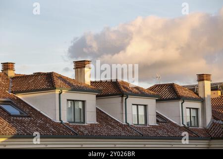 Blick von der generischen Apartment Gebäude mit Dachfenster und Tondachziegel bei Sonnenuntergang Stockfoto