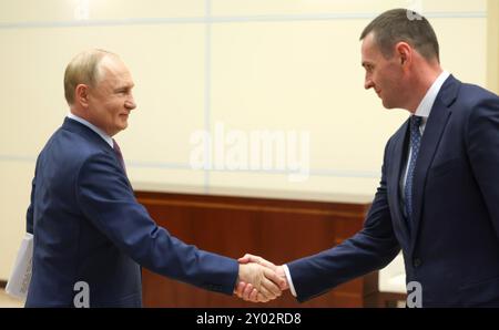 Novo-Ogaryovo, Russland. 30. August 2024. Der russische Präsident Wladimir Putin, links, begrüßt den amtierenden Gouverneur des Gebiets Tschabarowsk Dmitri Demeshin, rechts, zu einer persönlichen Arbeitssitzung in der offiziellen Präsidialresidenz am 30. August 2024 in Novo-Ogarjowo, Oblast Moskau, Russland. Quelle: Alexander Kazakov/Kreml Pool/Alamy Live News Stockfoto