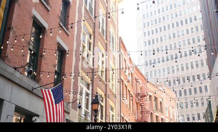 New York City Gebäudearchitektur. Wohnhaus außen. Immobilien, US-Flagge. Typische rote Ziegelfassade. Manhattan Downtown Financial District, Stone Street, FIDI. Fluchtleiter Stockfoto