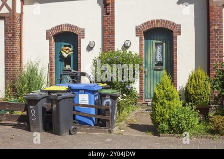 Bunte Mülleimer stehen vor einem Hauseingang, Delmenhorst, Niedersachsen, Deutschland, Europa Stockfoto