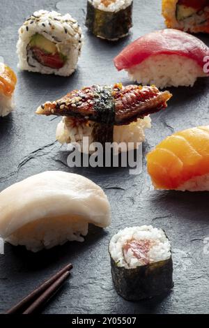 Sushi auf schwarzem Hintergrund. Nigiri mit Aal, Thunfisch und Weißfisch auf schwarzem Hintergrund, japanisches Essen auf einem Teller in einem asiatischen Restaurant Stockfoto