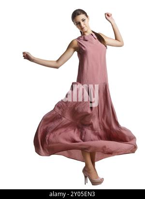 Porträt des schönen brünetten Mädchens im langen rosa Kleid Stockfoto