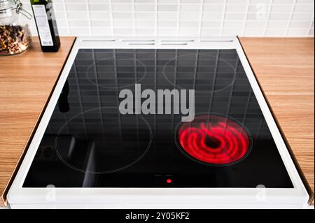 Elektischer Keramikofen. Induktionskochfeld aus Glas. Kochfeld, Herd und Kochfeld zum Kochen. Küchenherd. Rote Warmhalteplatte, Einschalten. Stockfoto