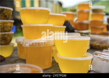 Verkauf von Honig im Freien in Plastikgläsern Stockfoto