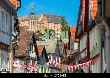 Blick auf das Marburger Schloss über den Dächern von Fachwerkhäusern in der Altstadt von Marburg, Deutschland Stockfoto