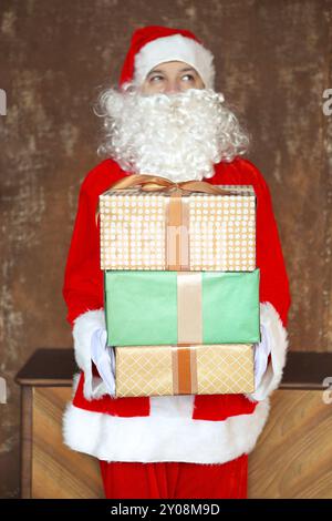 Santa Claus insgeheim anbringen Geschenkboxen unter den Weihnachtsbaum. Weihnachten Stockfoto