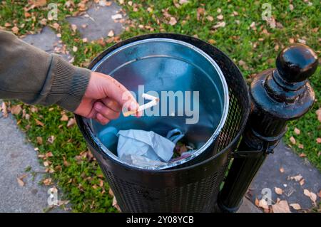 Nahaufnahme der männlichen Hand, die zerbrochene Zigarette in den Mülleimer wirft. Aufhören zu rauchen und gesund Leben Konzept. Stockfoto