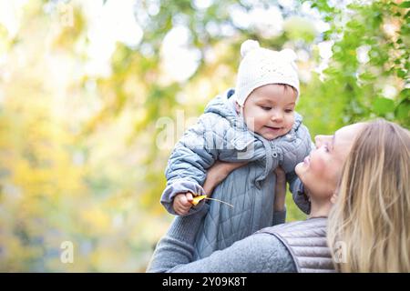 Happy Family im Freien. Mutter und ihre kleine Tochter spielen, kuscheln sich Herbst Spaziergang in der Natur im Freien Stockfoto