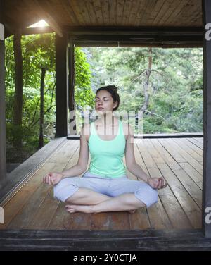 Junge Frau tut Yoga Asana am Abend im freien Stockfoto