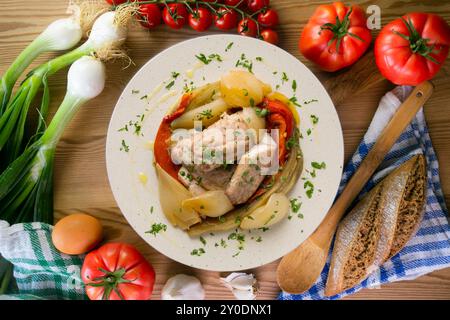 Gebackene Makrele mit Esccalivada-Gemüse, Paprika, Zwiebeln und Auberginen. Tisch mit Draufsicht und Dekoration. Stockfoto