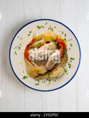 Gebackene Makrele mit Esccalivada-Gemüse, Paprika, Zwiebeln und Auberginen. Tisch mit Draufsicht und Dekoration. Stockfoto