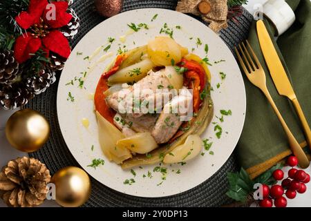 Gebackene Makrele mit Esccalivada-Gemüse, Paprika, Zwiebeln und Auberginen. Tisch mit Panoramablick und Weihnachtsdekoration. Stockfoto