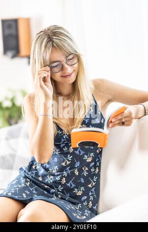 Eine junge Dame liest ein Buch und trägt eine Brille. Stockfoto