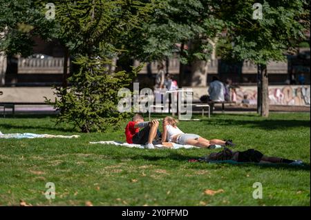 Tiflis, Georgien - 8. Oktober 2023: Freunde genießen einen sonnigen Tag auf grasbewachsenen Parkdecken. Stockfoto