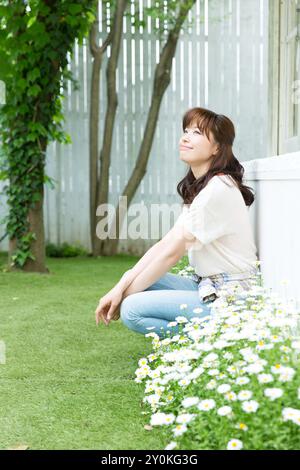 Junge Frau im Garten entspannen Stockfoto