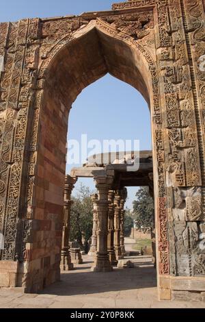 Damaged Arches, Qutab Minar Complex, Süd-Delhi, Indien. Wunderschön geschnitzte Bögen, beschädigt und Touristen besuchen. Stockfoto