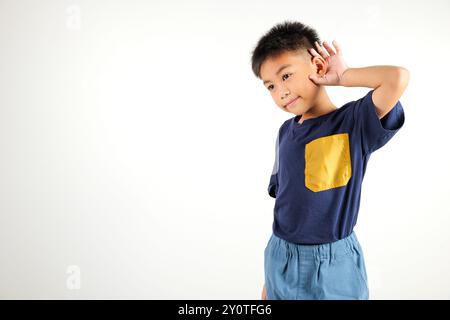 Portrait Asiatisches kleines Kind lächelnd hörend hörend Tratsch mit Aufmerksamkeit mit der Hand Stockfoto