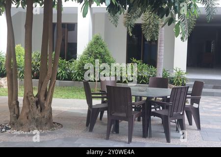 Die Stühle befinden sich im Garten, bequem zum Genießen von Kaffee und anderen Getränken. Stockfoto