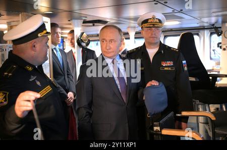 Wladiwostok, Russland. September 2024. Der russische Präsident Wladimir Putin, Mitte, begibt sich mit dem Kommandeur der Pazifikflotte Viktor Liina, rechts, und dem Schiffskommandeur Jewgeni Kowalew, links, an der Primorje Flottille der All-Arms Forces am 4. September 2024 in der Uliss-Bucht, Wladiwostok, Russland, auf der russischen Flotte. Quelle: Vyacheslav Prokofyev/Kreml Pool/Alamy Live News Stockfoto